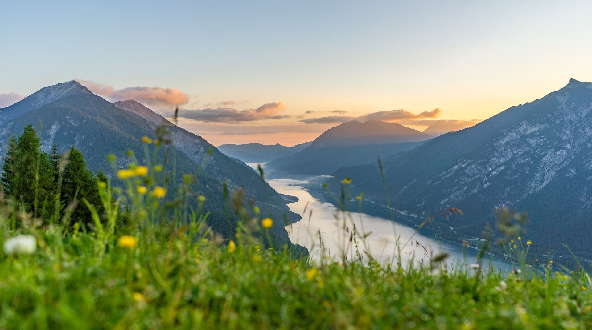 Berglandschaft mit Fluss im Sonnenuntergang